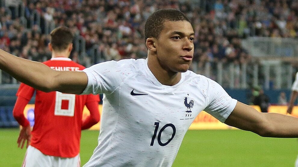 Kylian Mbappé celebrating a goal for PSG, cementing his position as one of the highest paid footballers