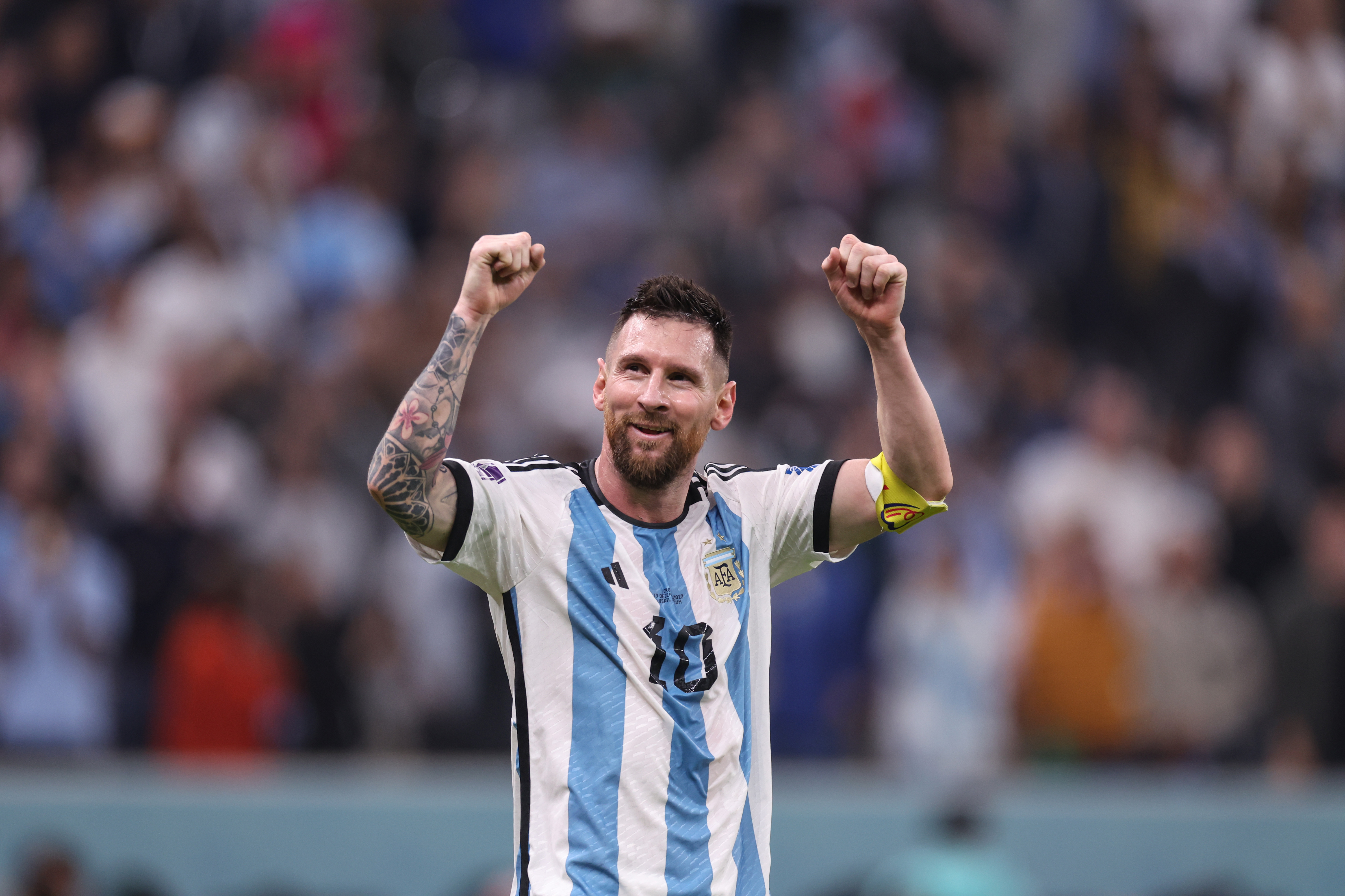 Lionel Messi celebrates with the World Cup trophy
