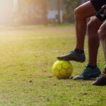 Football player performing toe taps on a ball