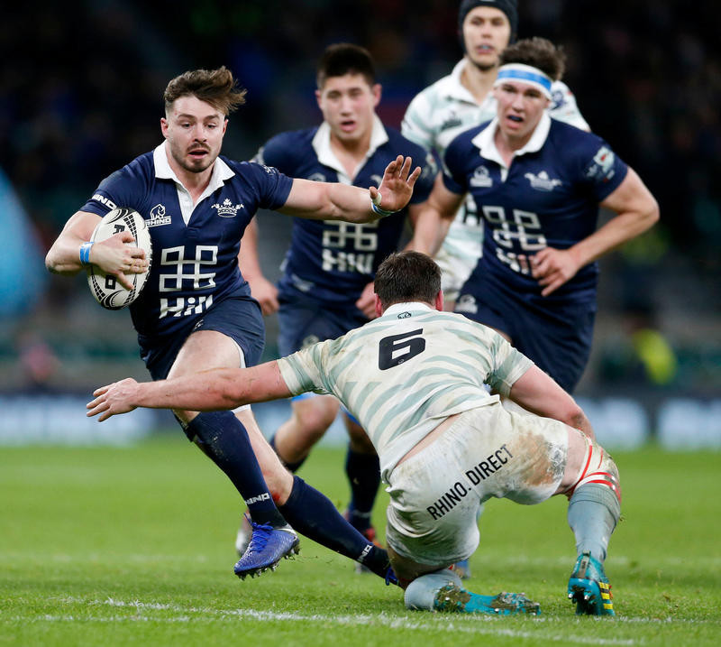 Ben Ransom of Oxford Rugby skillfully avoids a Cambridge tackler in the Varsity Match