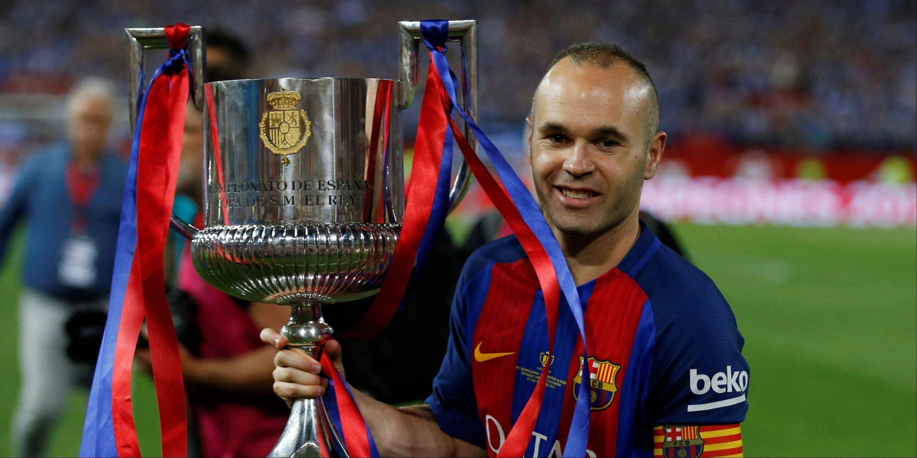 Andres Iniesta with a Barcelona trophy