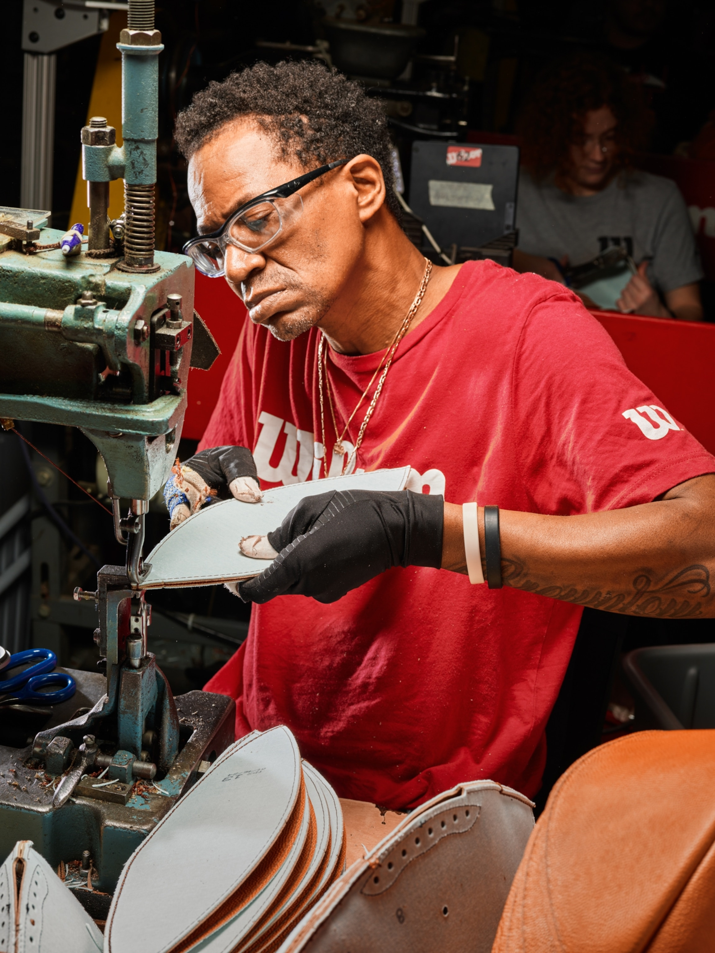 Leather panels being cut for a football.