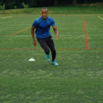Football player performing squats to improve lower body strength
