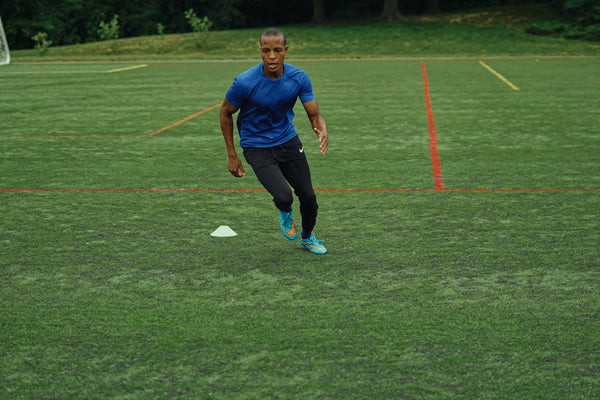 Football player performing squats to improve lower body strength