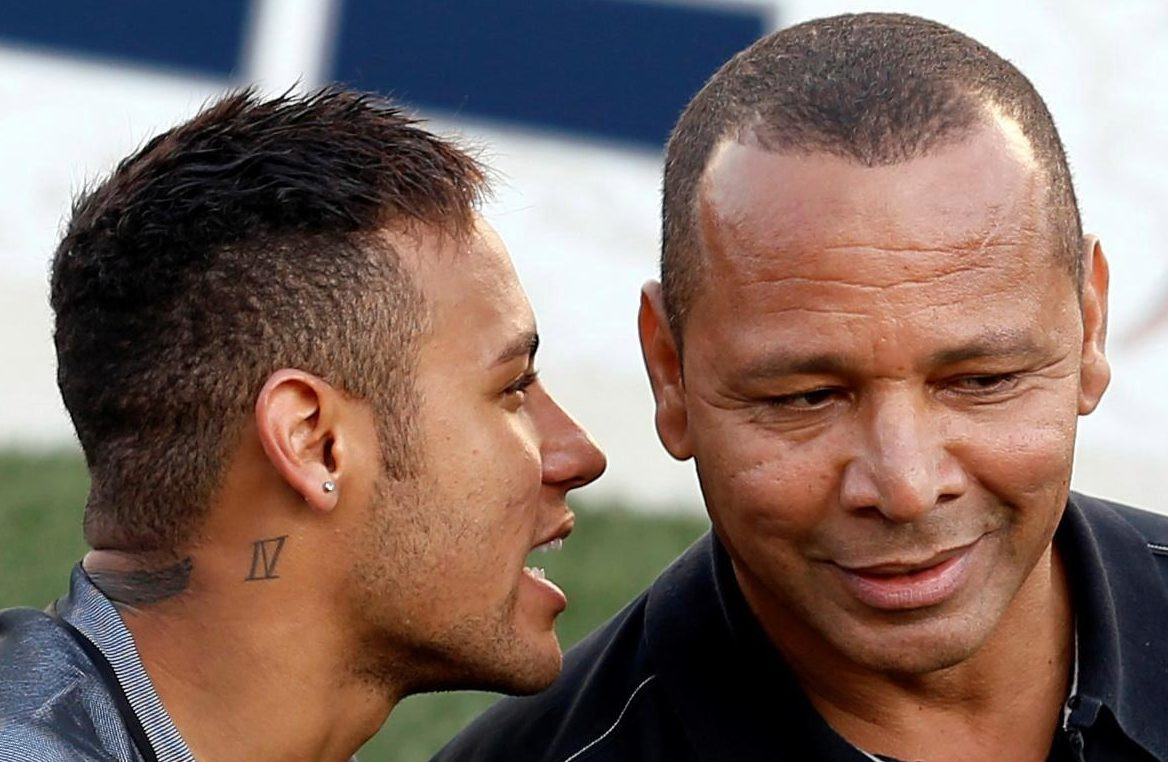 Neymar Jr. and Neymar. Sr. enjoy a chin wag as they watch Neymar Jr.