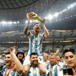 Lionel Messi lifting the World Cup trophy, a crowning moment in his career