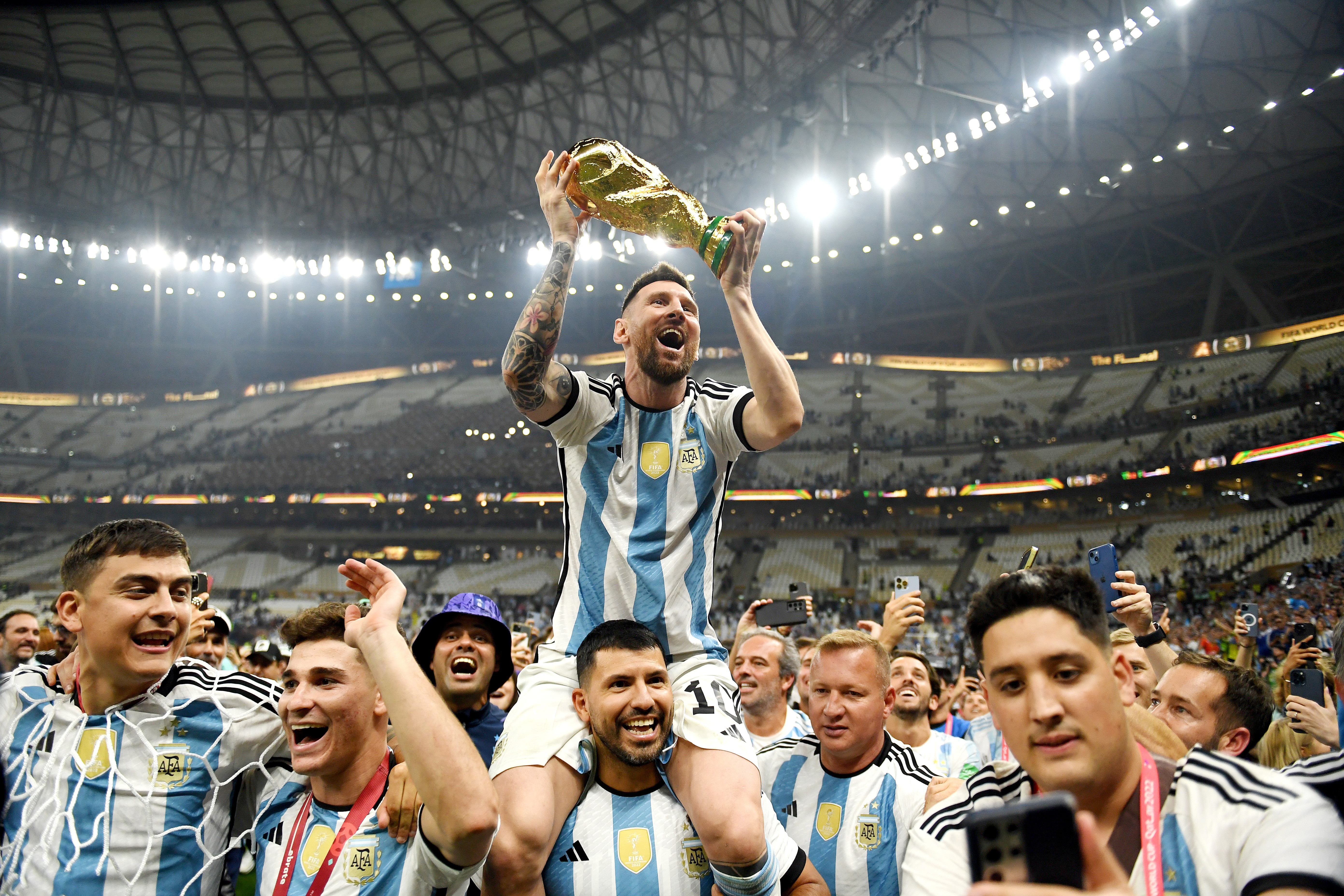 Lionel Messi lifting the World Cup trophy, a crowning moment in his career