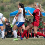 female soccer players fight for the ball during a match