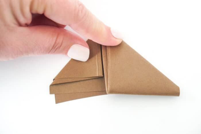 Tucking the last paper flap to finish the football