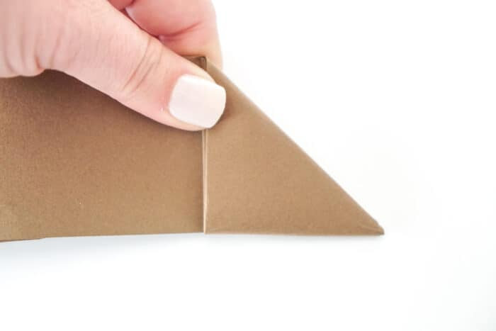 Continuing to fold the triangle down the paper strip