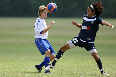 Young football player writing in a notebook