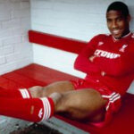 John Barnes poses in the home team dug out for an official photograph shortly after signing for Liverpool from Watford at Anfield on June 09, 1987 in Liverpool, England.