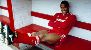 John Barnes poses in the home team dug out for an official photograph shortly after signing for Liverpool from Watford at Anfield on June 09, 1987 in Liverpool, England.