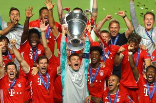 Bayern Munich captain Manuel Neuer lifts the Champions League trophy alongside his team-mates after the Bavarians
