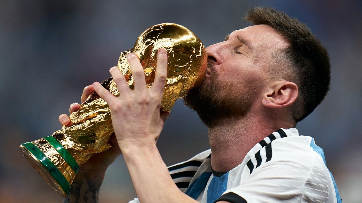 Lionel Messi with the World Cup trophy