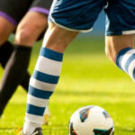 Footballer having his leg treated. Shaved legs can provide quick access for medical staff