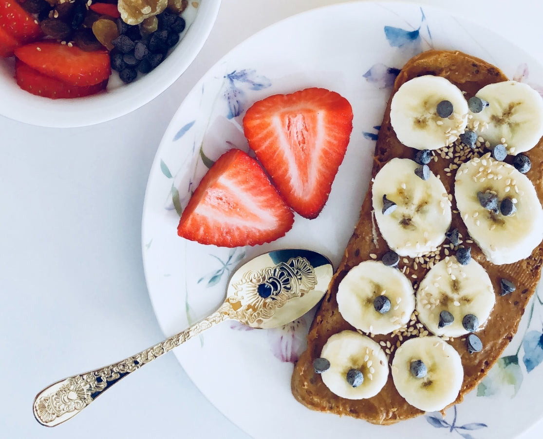 A healthy post-workout snack consisting of peanut butter and banana on toast, representing a balance of protein and carbohydrates for muscle recovery