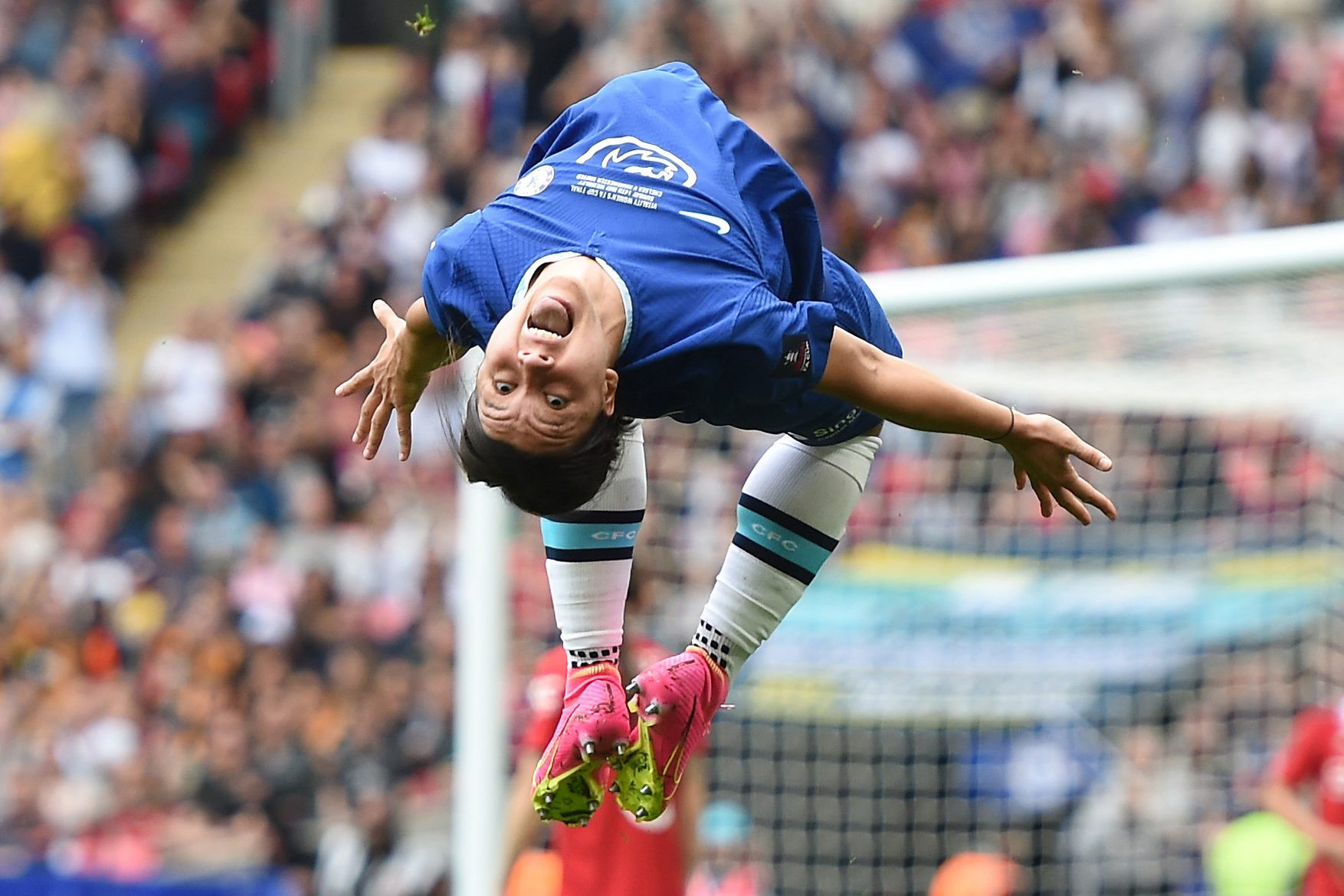 Sam Kerr in mid air as she performs a flip to celebrate a goal