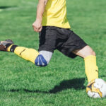 Soccer player controlling the ball with the inside of their foot