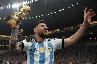 Lionel Messi of Argentina celebrates with the FIFA World Cup Qatar 2022 Winner