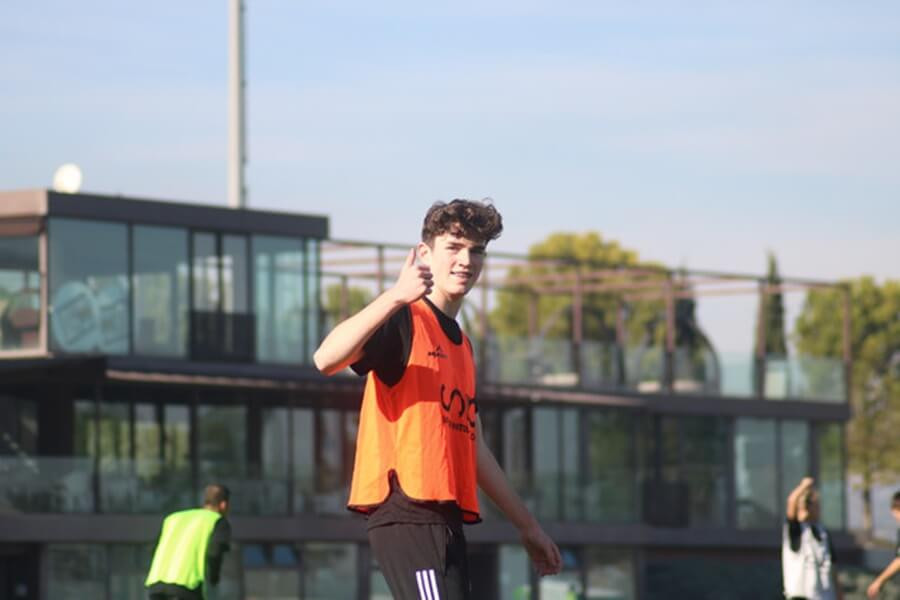 SIA Academy coaches providing personalized instruction and guidance during a summer football camp training session, ensuring each player receives the attention they need to improve their skills