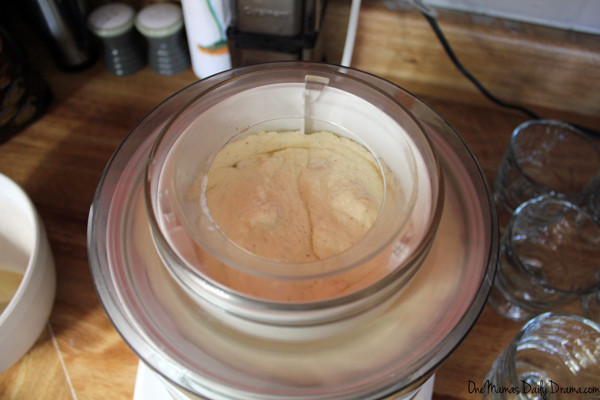 vanilla ice cream churning in an ice cream maker on a countertop