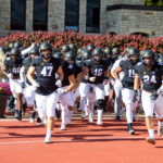 St. Olaf football team runs onto Klein Field during a home game this season