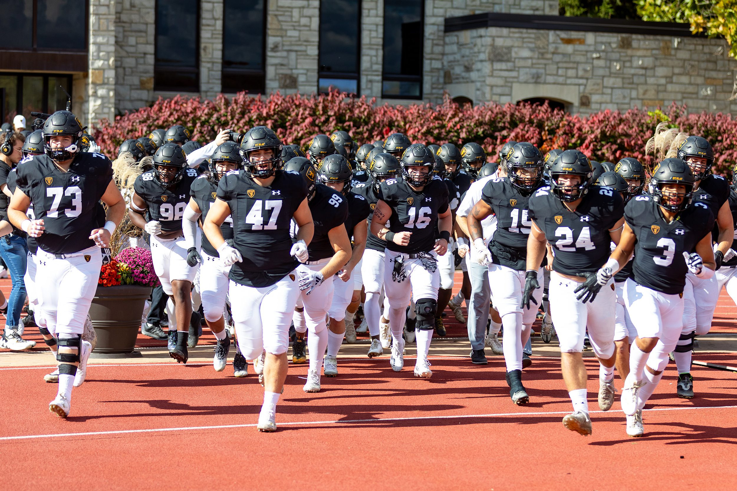 St. Olaf football team runs onto Klein Field during a home game this season