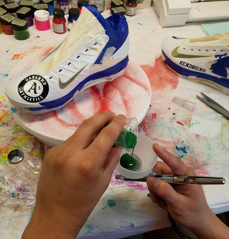 Straining a mixture of Angelus and 2-thin into my airbrush.