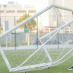 A man moves a movable goal into position - Back of the net!