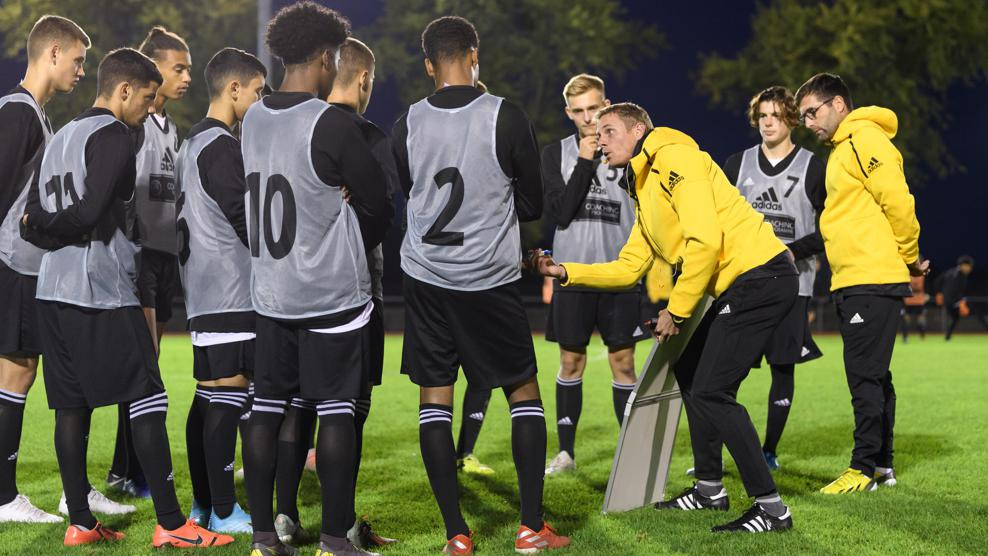 Coaches giving instructions to young players at a UEFA Pro License exchange