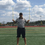 Referee signaling a penalty in football