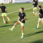 A female soccer player warming up before a match.