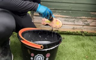 Scrubbing the soles of Adidas football boots