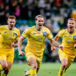 Ukrainian players celebrate victory in the Euro 2024 play-off final against Iceland