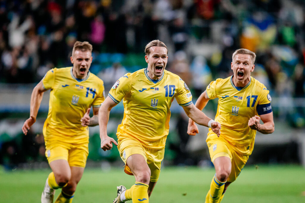 Ukrainian players celebrate victory in the Euro 2024 play-off final against Iceland