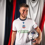 George Thomason wearing Bolton Wanderers 2024/25 home kit