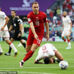 Christian Eriksen during a match, showcasing his return to professional football