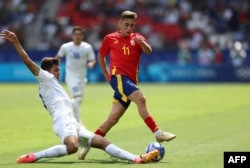 Khusanov, seen here tackling Fermin Lopez in Uzbekistan