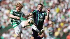 Mykola Kuharevich challenges a Celtic player for the ball in a game for Hibernian