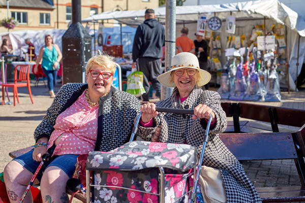 Two ladies enjoying the sunshine on market day
