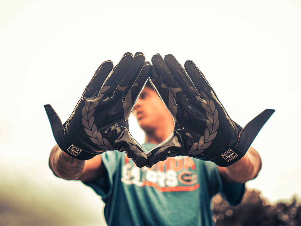 Close up image of a player wearing football gloves.