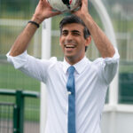Rishi Sunak holding a soccer ball, showcasing his interest in football