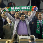 Former owner Ali Syed holding up a Racing Santander scarf in March 2011