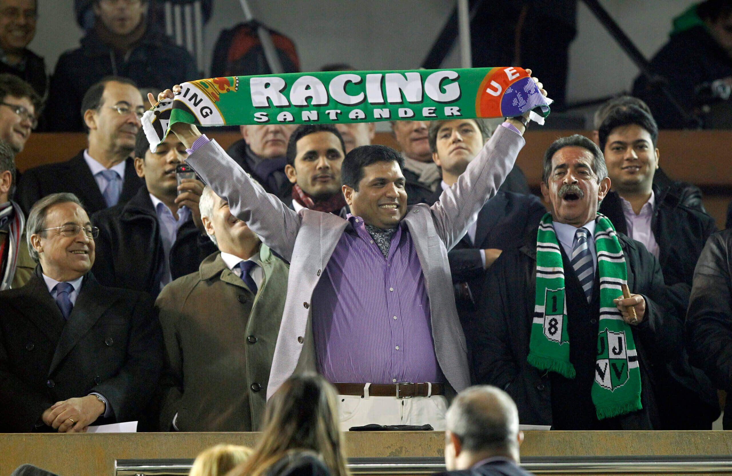 Former owner Ali Syed holding up a Racing Santander scarf in March 2011