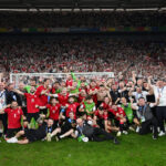 Georgia's players and staff celebrate a famous victory