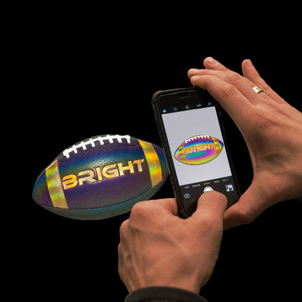 Player holding football with gloves