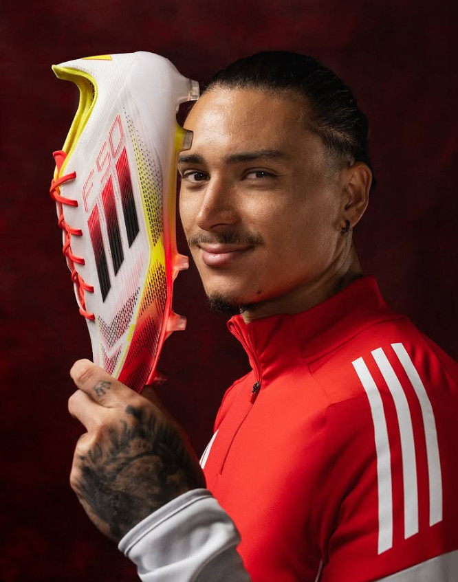 Image showing a person trying on different football boots