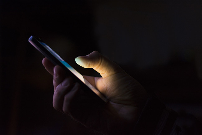 Man scrolling through phone.