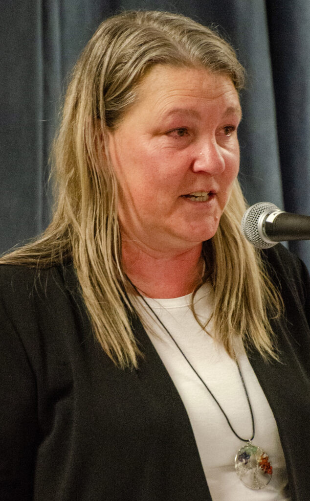 Lisa Agnew delivering a eulogy, highlighting her brother-in-law's kindness and compassion at the memorial service.